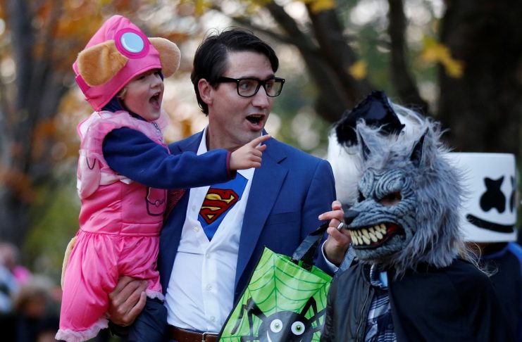 Canada’s PM Trudeau carries his son Hadrien while participating in Halloween festivities at Rideau Hall in Ottawa