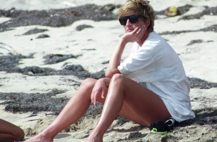 Princess Diana relaxes on the sand during a visit to the beach on the Caribbean Island of Nevis