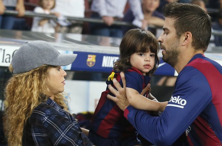 Singer Shakira passes their son Milan to Barcelona’s Pique before the Spanish first division soccer match between Barcelona and Eibar at Camp Nou stadium in Barcelona