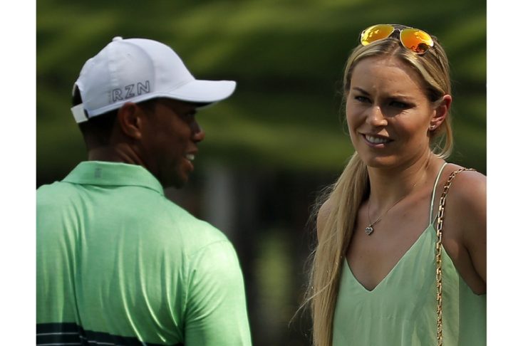 U.S. golfer Woods and Vonn smile during the par 3 event held ahead of the 2015 Masters at Augusta National Golf Course in Augusta