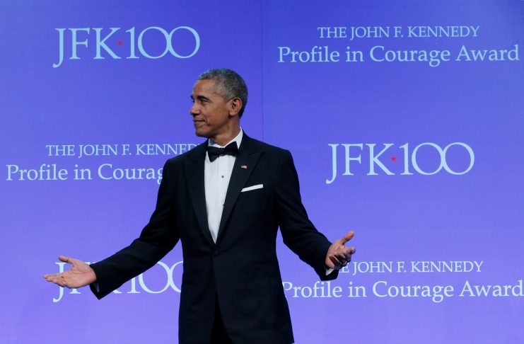 Former U.S. President Barack Obama stands onstage after receiving the 2017 Profile in Courage Award during a ceremony at the John F. Kennedy Library in Boston