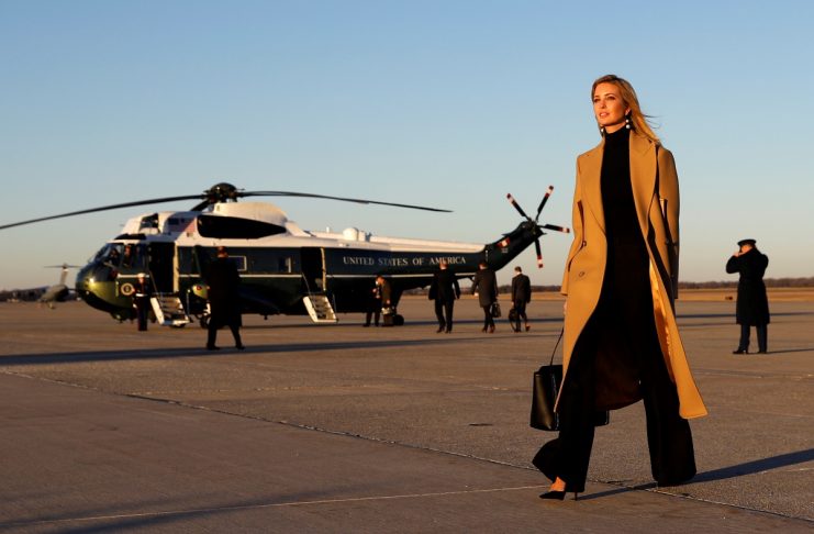 Ivanka Trump walks from Air Force One to a waiting vehicle upon arrival, as U.S. President Donald Trump boards Marine One in the background, at Joint Base Andrews in Maryland