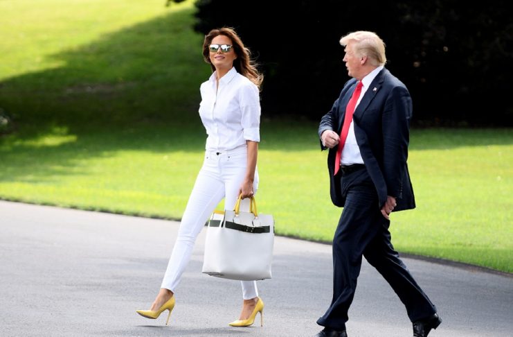 U.S. President Donald Trump and First Lady Melania Trump walk to Marine One upon departure from the White House, in Washington