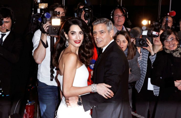 FILE PHOTO —  Actor George Clooney and his wife Amal pose as they arrive at the 42nd Cesar Awards ceremony in Paris