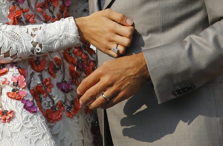 Wedding rings are seen on the hands of U.S. actor Clooney and his wife Alamuddin as they stand in a water taxi on the Grand Canal in Venice