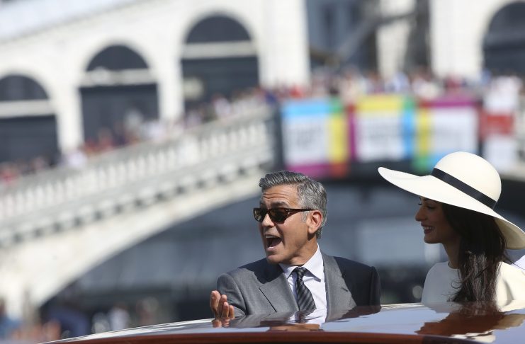 U.S. actor George Clooney and his wife Amal Alamuddin arrive at Venice city hall for a civil ceremony to formalize their wedding in Venice