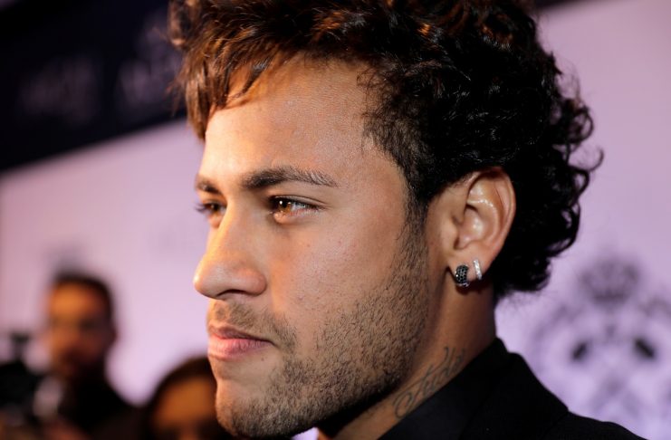 Soccer player Neymar poses at red carpet during an auction to raise funds to his Institute Project Neymar Jr in Sao Paulo