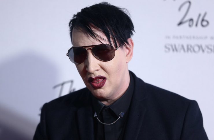 Singer Marilyn Manson poses for photographers at the Fashion Awards 2016 in London