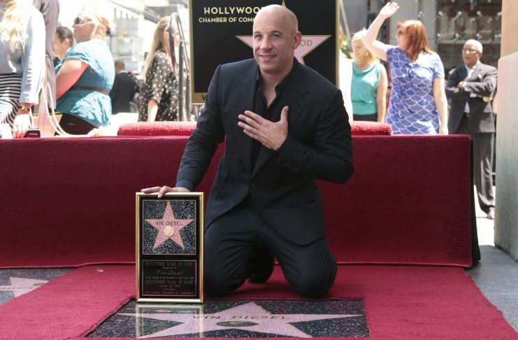Actor Vin Diesel poses with his newly unveiled star on the Hollywood Walk of Fame in Hollywood, California
