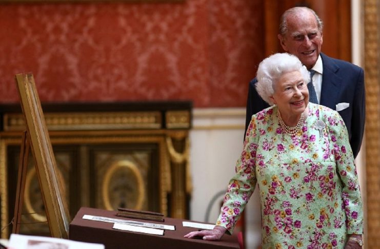 Britain’s Queen Elizabeth II and Prince Philip, Duke of Edinburgh stand next to a display of Spanish items from the Royal Collection at Buckingham Palace