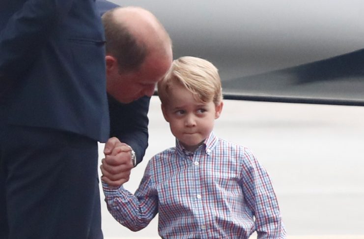 Prince William, the Duke of Cambridge and Prince George are seen as they arrive at a military airport in Warsaw