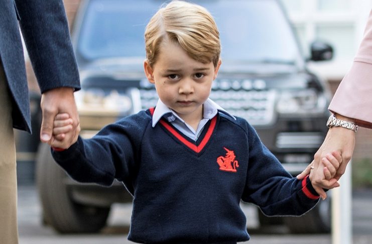Prince George holds his father Britain’s Prince William’s hand as he arrives on his first day of school at Thomas’s school in Battersea, London