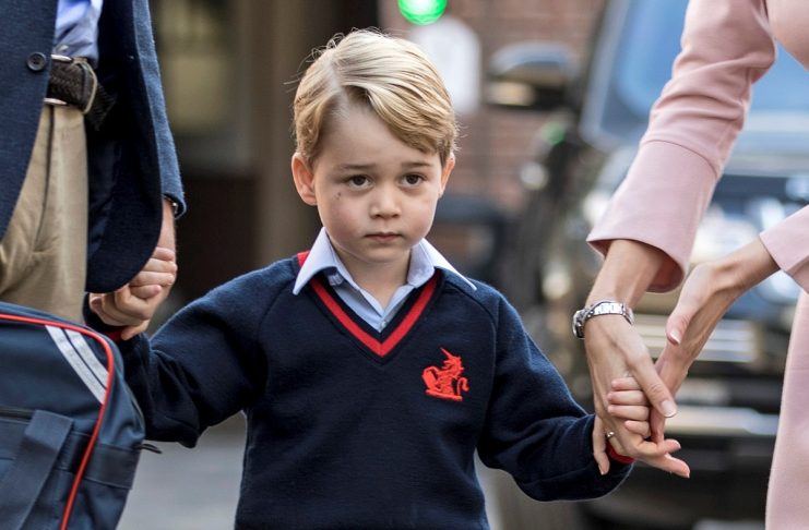 Helen Haslem, head of the lower school and Britain’s Prince William hold Prince George’s hands as he arrives for his first day of school at Thomas’s school in Battersea, London