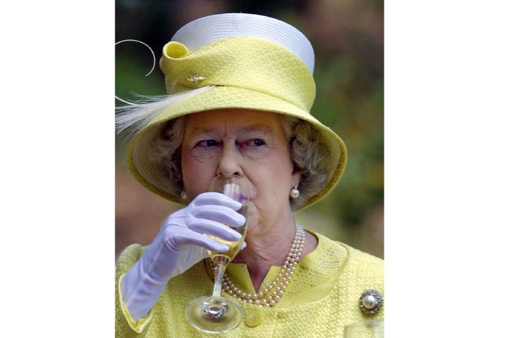 Britain’s Queen Elizabeth II takes a sip of wine with during a wine country tour in Barossa Valley n..