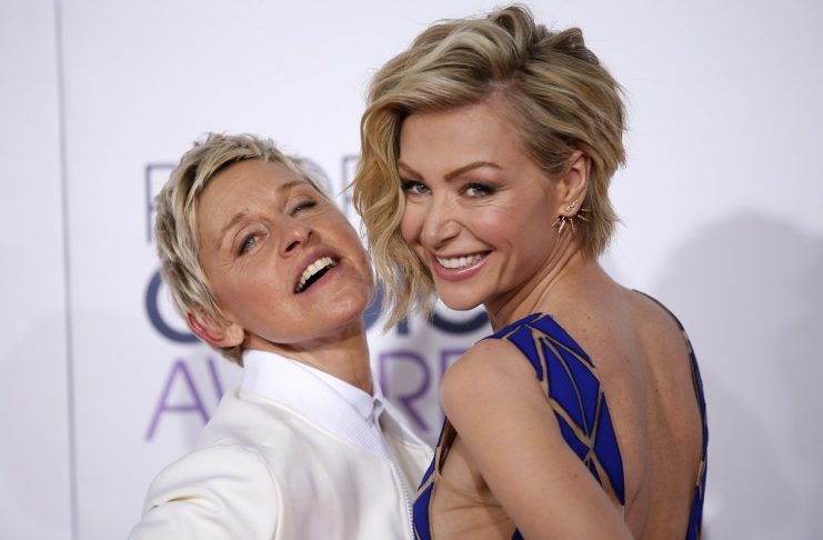 TV personality Ellen DeGeneres arrives with her spouse, actress Portia di Rossi at the 2015 People’s Choice Awards in Los Angeles