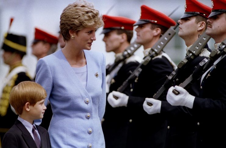 Princess of Wales, Lady Diana, inspects with her eight-year-old son, Prince Harry, troops at the reg..