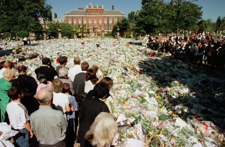 -FILE PHOTO- Mourners gaze at  a carpet of flowers outside Kensington Palace September 4. Thousands ..