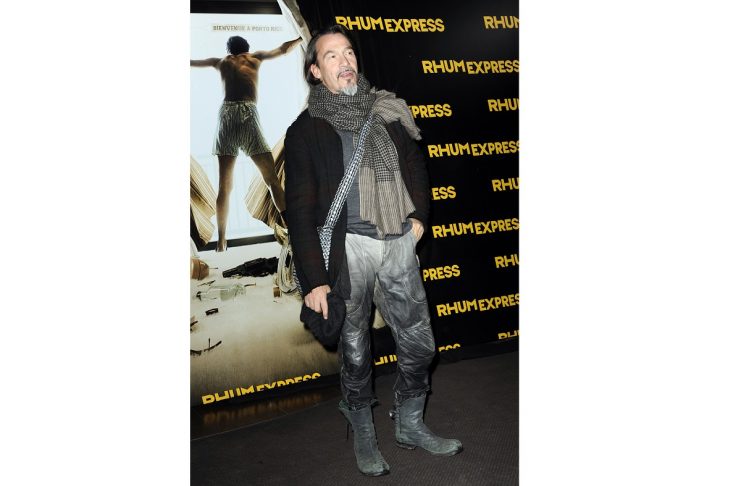 Singer Pagny poses for photographers as he arrives for the premiere of the film “The Rum Diary” in Paris