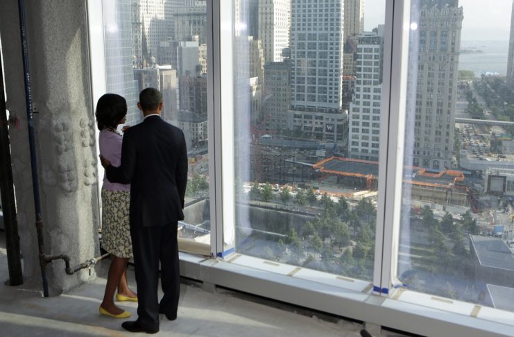 U.S. President Barack Obama and first lady Michelle Obama look down at the 9/11 Memorial while touring the One World Trade Center building which is under construction in New York