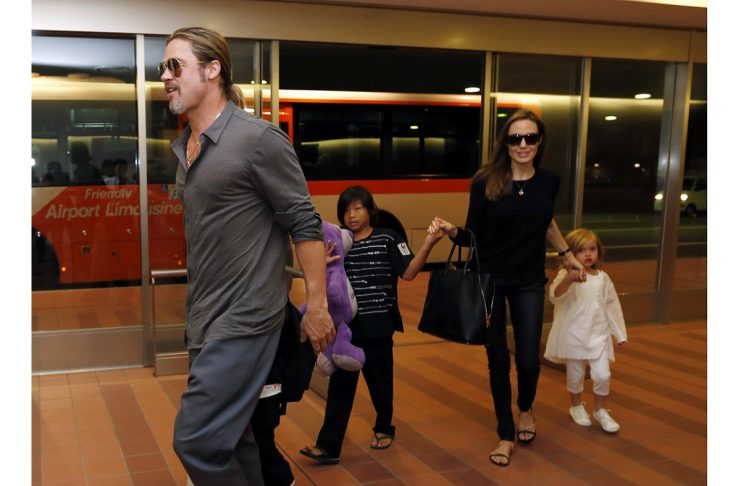 Hollywood actors Brad Pitt and actress Angelina Jolie arrive with their children at Haneda international airport in Tokyo