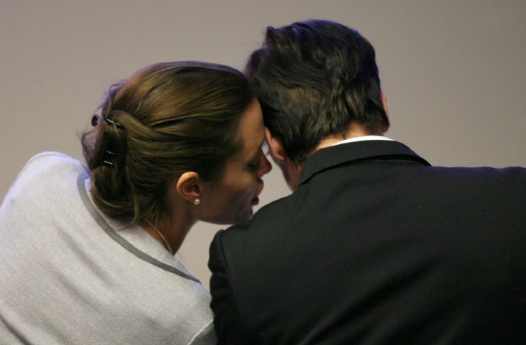 US actress Angelina Jolie whispers to US actor Brad Pitt at the World Economic Forum in Davos