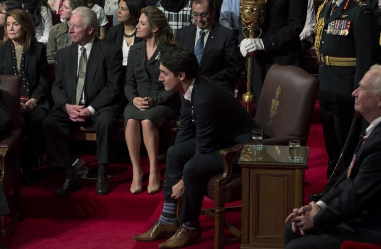 Canada’s PM Trudeau pulls up his socks before the start of the Speech from the Throne on Parliament Hill in Ottawa