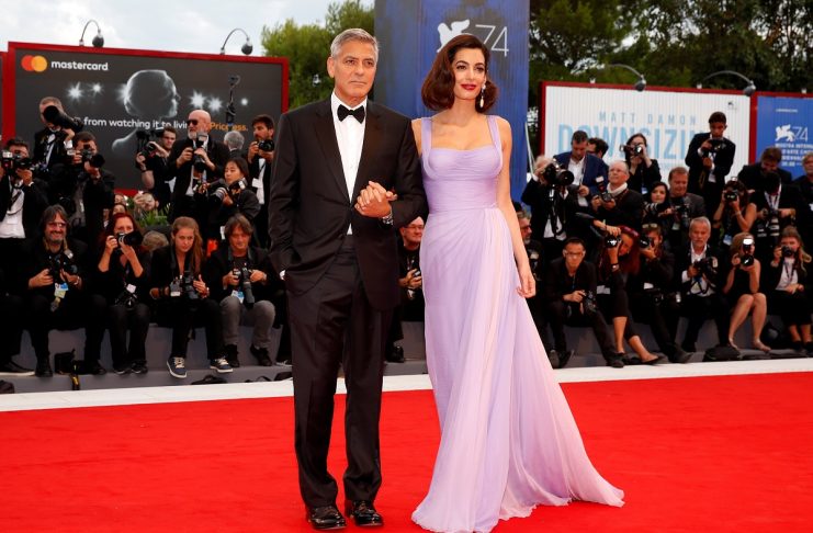 Actor and director George Clooney and his wife Amal pose during a red carpet event for the movie “Suburbicon” at the 74th Venice Film Festival in Venice, Italy
