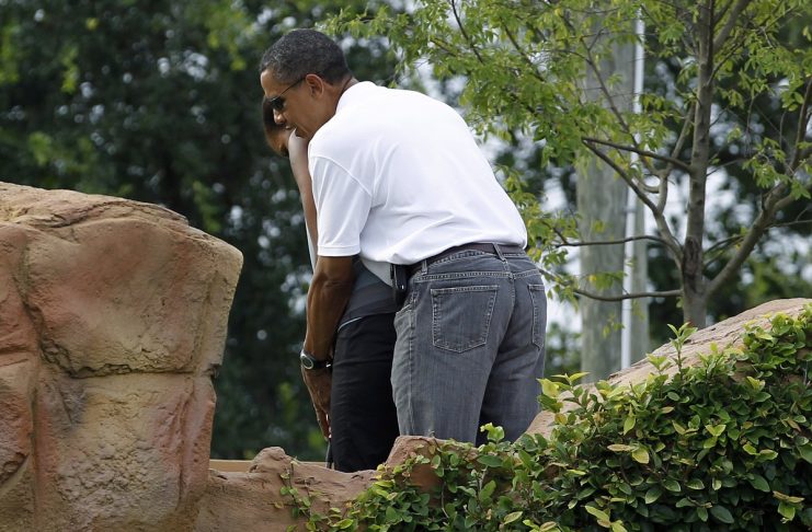U.S. President Obama gives instruction to his wife Michelle during a round of putt putt golf in Panama City Beach