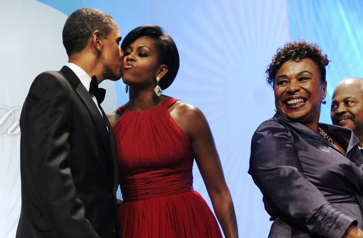 US President Obama kisses his wife Michelle after being announced to speak by Lee and Payne at the Congressional Black Caucus Foundation’s Legislative Conference Phoenix Awards Dinner in Washington