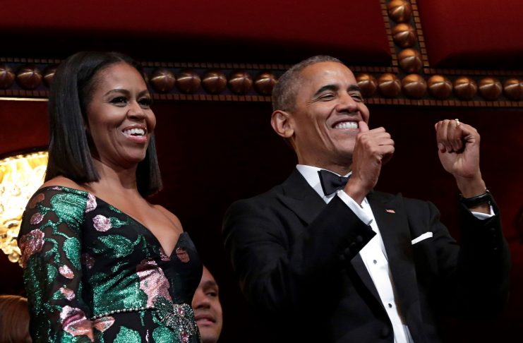 U.S. President Barack Obama gestures as he and first lady Michelle Obama attend the Kennedy Center Honors in Washington