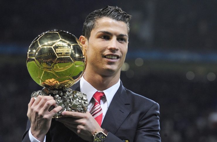 Manchester United’s Ronaldo poses with Ballon D’Or trophy ahead of their Champions League soccer match against AaB Aalborg in Manchester