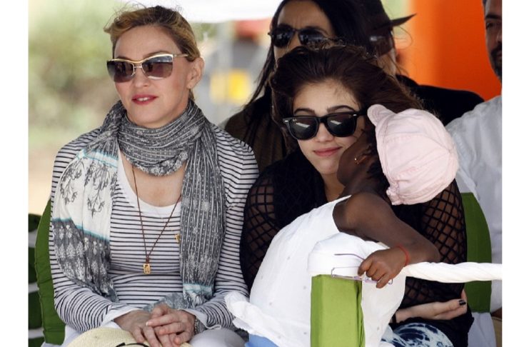 Madonna sits with her adopted Malawian child Mercy James and daughter Lourdes during a bricklaying ceremony at the site of her Raising Malawi Girls Academy