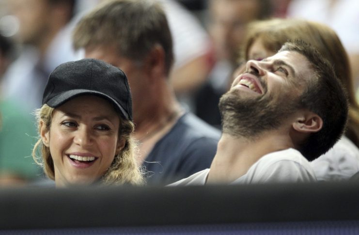 Colombia’s singer Shakira and her partner Barcelona’s soccer player Pique share a laugh as they attend at the Basketball World Cup quarter-final game between U.S. and Slovenia in Barcelona