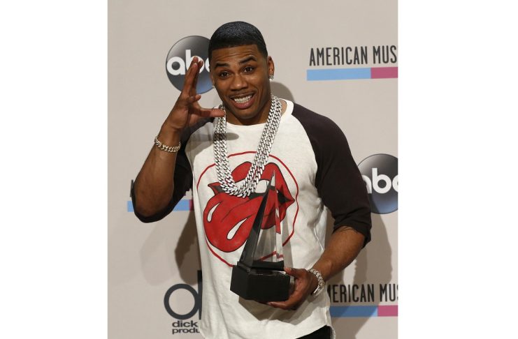 Hip hop artist Nelly poses with the single of the year award for the Florida Georgia Line song “Cruise” backstage at the 41st American Music Awards in Los Angeles