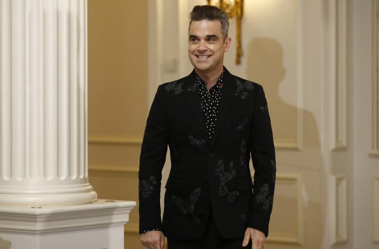 British singer Robbie Williams arrives at a news conference at the Savoy hotel in central London