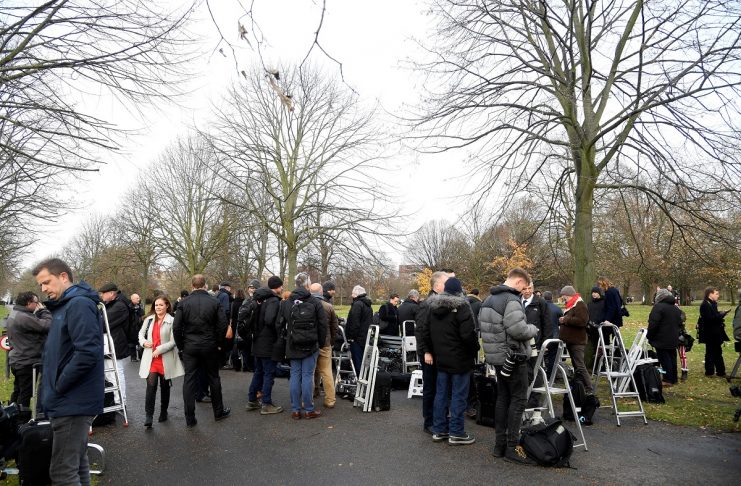 Members of the media wait in the grounds of Kensington Palace to photograph and film Prince Harry and Meghan Markle, in London