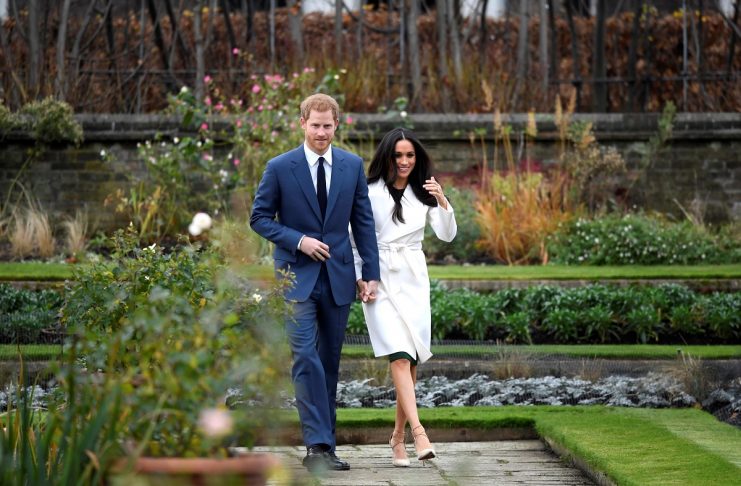 Britain’s Prince Harry walks with Meghan Markle in the Sunken Garden of Kensington Palace