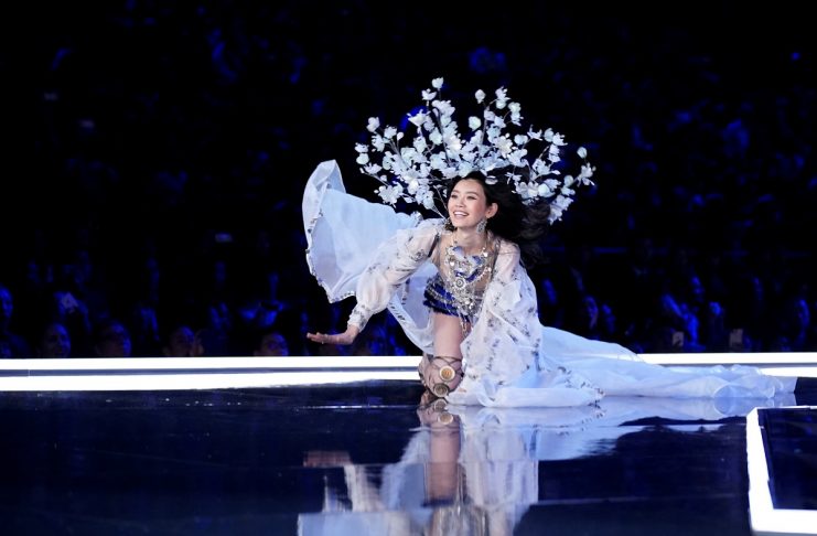 Model Ming Xi falls as she presents a creation during the 2017 Victoria’s Secret Fashion Show in Shanghai