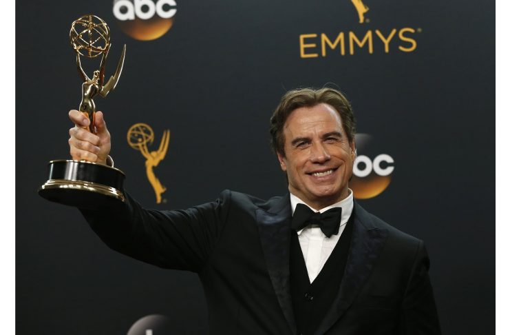 Actor John Travolta poses backstage with the award for Outstanding Limited Series at the 68th Primetime Emmy Awards in Los Angeles