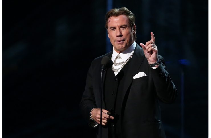Actor John Travolta introduces Keith Urban and Carrie Underwood at the 59th Annual Grammy Awards in Los Angeles