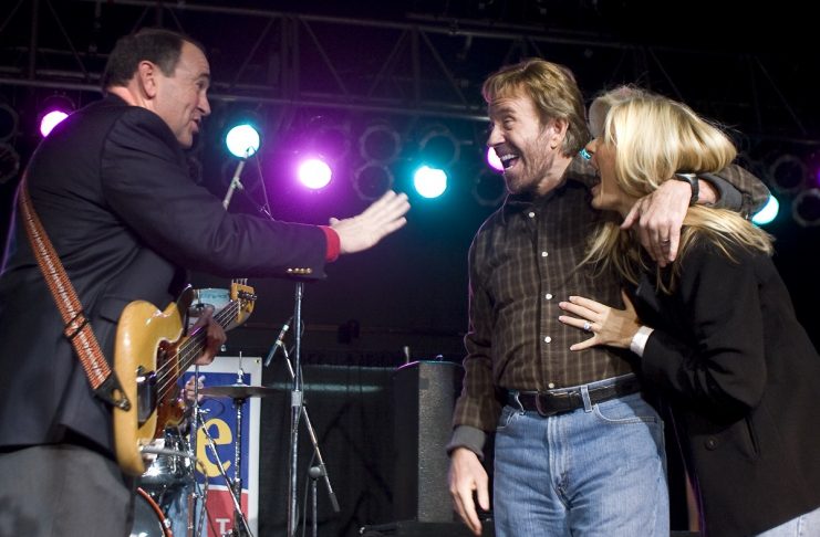 Governor Mike Huckabee jokes with actor Chuck Norris during campaign rally in Des Moines