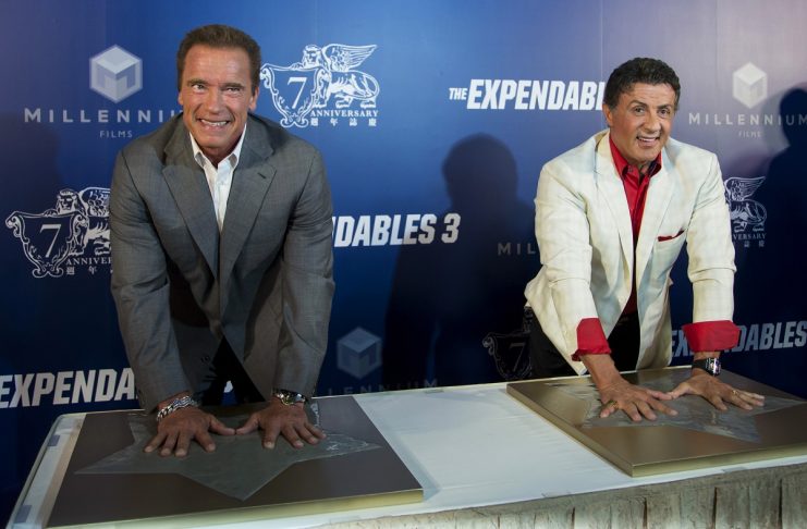 Schwarzenegger and Stallone place their hand prints before the special screening of “The Expendables 3” in Macau