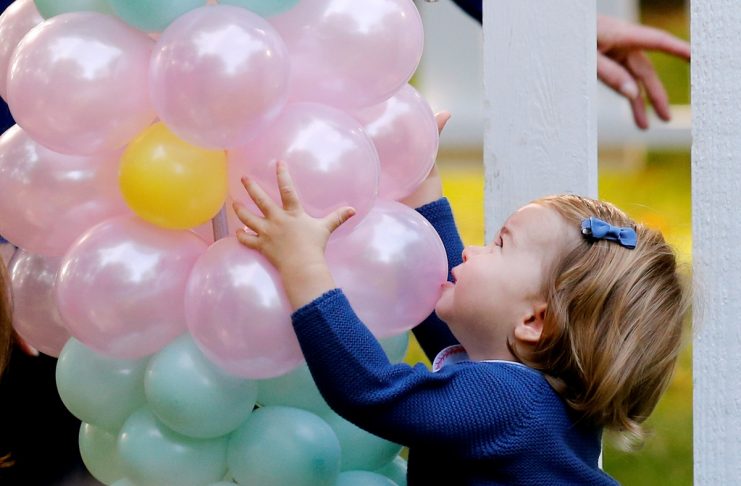 Britain’s Princess Charlotte plays with baloons at a children’s party at Government House in Victoria