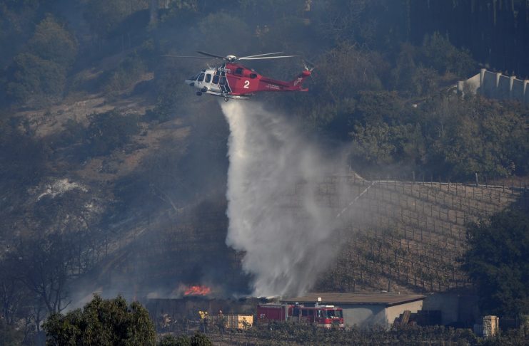 A fire department helicopter makes a water drop building on the vineyard estate of media mogul Rupert Murdoch catches fire during the Skirball fire in Bel Air, a wealthy neighborhood on the west side of Los Angeles