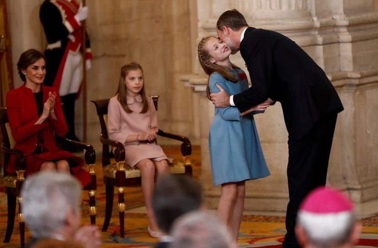 Spain’s King Felipe kisses his daughter Princess Leonor after presenting her with the insignia of the “Toison de Oro” (Order of the Golden Fleece) during a ceremony at the Royal Palace in Madrid