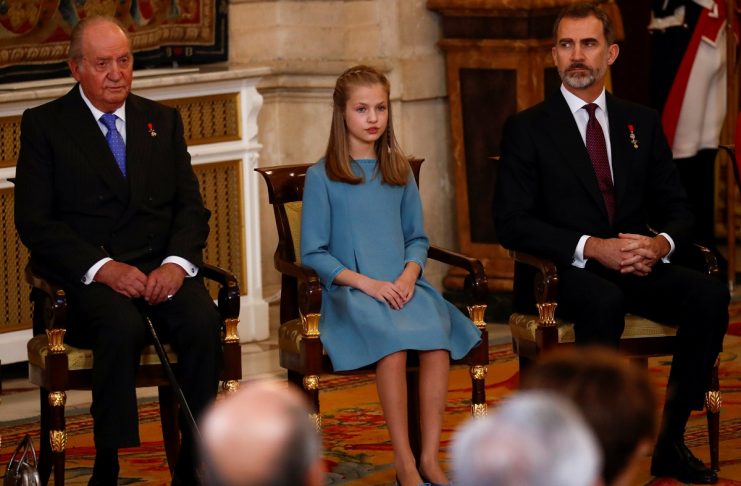 Spain’s former King Juan Carlos, Princess Leonor and King Felipe sit during a ceremony in which Princess Leonor was presented with the insignia of the “Toison de Oro” (Order of the Golden Fleece)  at the Royal Palace in Madrid