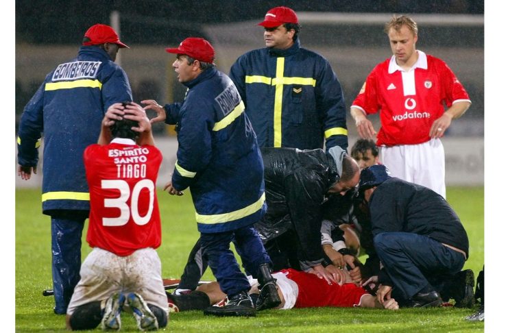 PLAYERS, RESCUE WORKERS AND MEDICS SURROUND BENFICA’S HUNGARIAN SOCCER STRIKER MIKLOS FEHER.