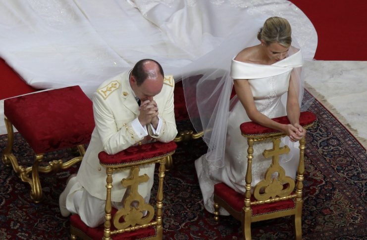 Monaco’s Prince Albert II and Princess Charlene pray during the religious wedding at the Palace in Monaco