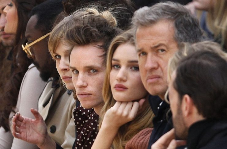 French actress Poesy, British actor Redmayne, British model Huntington-Whiteley and Peruvian photographer Testino watch the Burberry Prorsum 2012 Autumn/Winter collection show during London Fashion Week