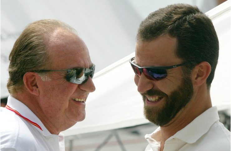 Spanish King Juan Carlos and Prince Felipe laugh on the island of Mallorca.